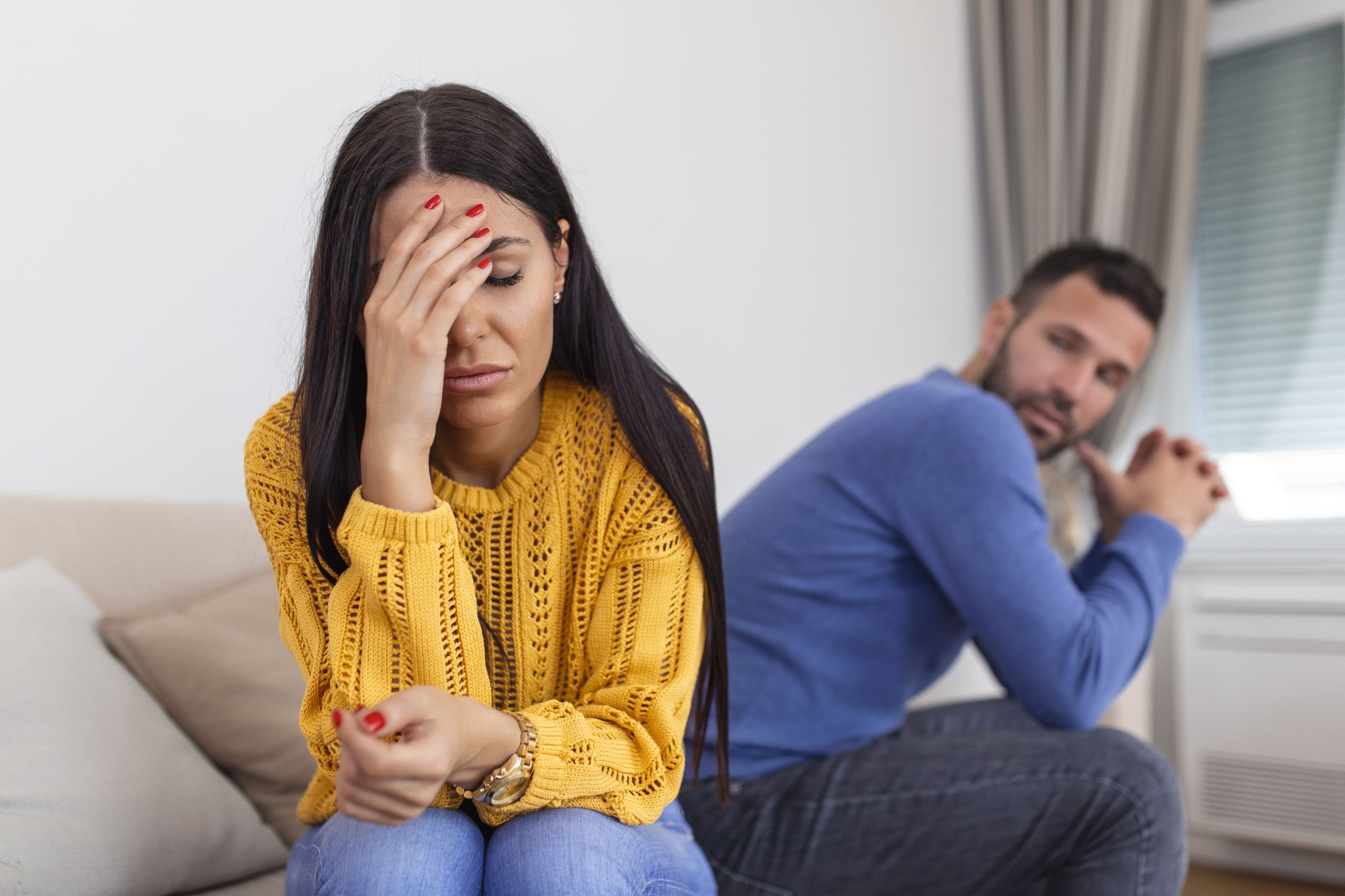 Imagem de um casal triste no sofá